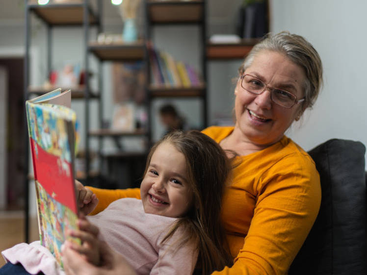 Grandparent reading with grandchildren; Bonding with grandkids through books; Fostering a love of reading in grandkids;